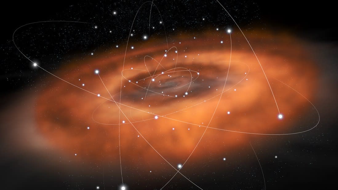  An illustration of the Milky Way's central black hole, wrapped in orange gas clouds and orbiting stars. 