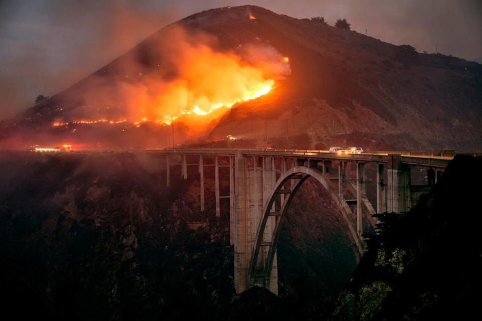 The Colorado Fire burns down toward the Bixby Bridge in Big Sur, Calif., early Saturday morning, Jan. 22, 2022. (Karl Mondon/Bay Area News Group via AP)