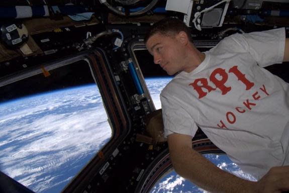 NASA astronaut Reid Wiseman floats in the cupola of the International Space Station.