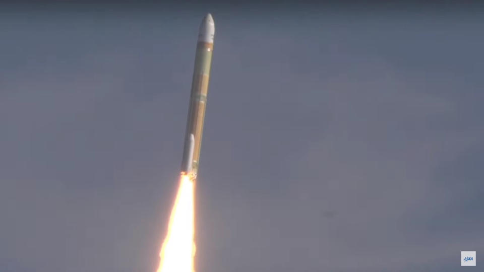 Japan's white and tan H3 rocket soars toward space with a cloudy blue sky in the background on F3b. 17, 2024.