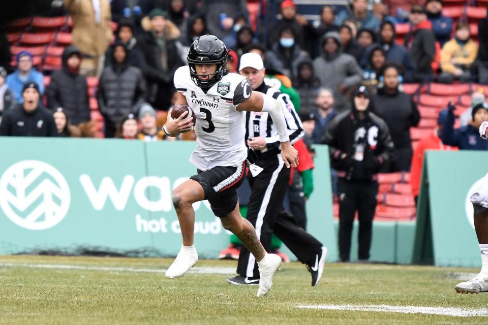 Cincinnati Bearcats quarterback Evan Prater (3) runs for a first down against the Louisville Cardinals during the first half at Fenway Park. Mandatory Credit: Eric Canha-USA TODAY Sports