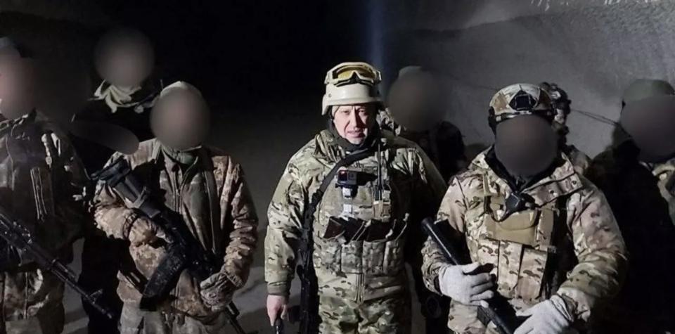 Wagner Group chief Yevgeny Prigozhin in military gear with several others, whose faces have been blurred, in what Russian state media described as the salt mines of Soledar, eastern Ukraine, on January 10 2022.