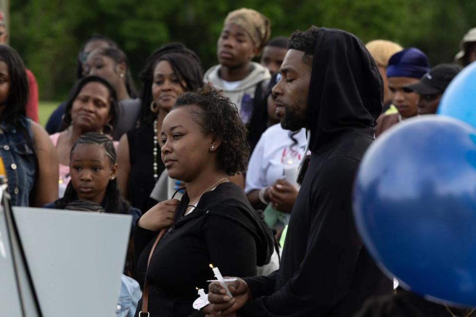 Friends and family of 13-year-old Jermel Ware, who recently passed away after a go-cart crash, held a candlelight vigil in Belleville’s Jaycee Park on Friday. Here, his parents listen as loved ones pay tribute and give testimony to Jermel’s character.