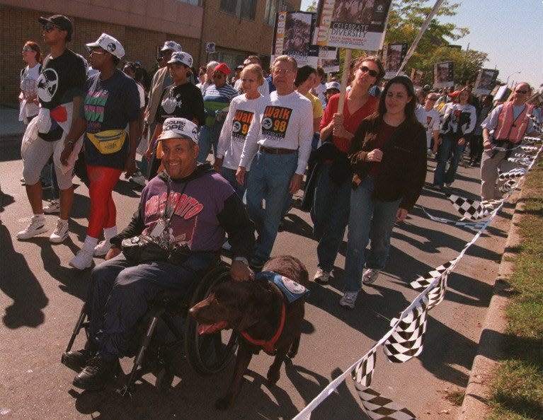 Larry Dilworth and his dog, Dever, start the FOCUS: Hope walk on Oct. 11, 1998. Larry was among thousands of people who participated in the annual event.