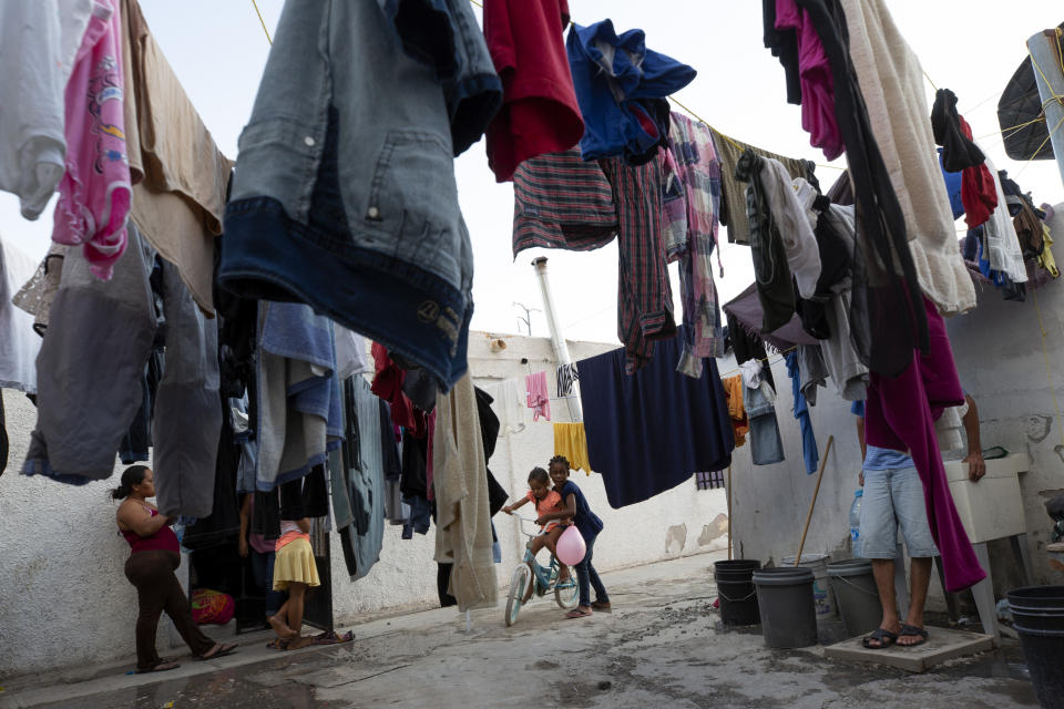 In this July 26, 2019, photo, a girl from Africa plays with a girl from Honduras at El Buen Pastor shelter for migrants in Cuidad Juarez, Mexico. (AP Photo/Gregory Bull)