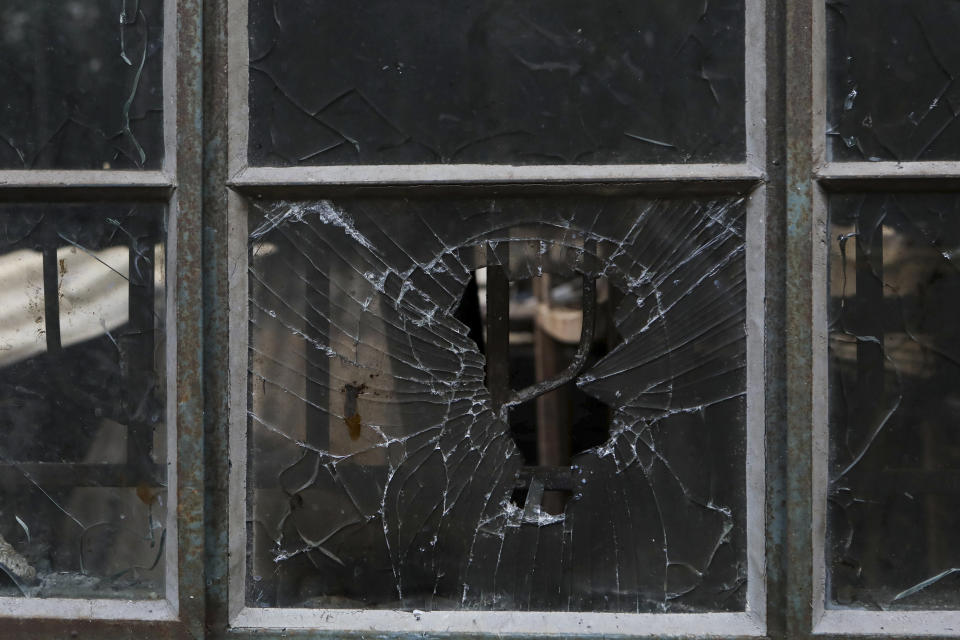 A bloodstain is seen on the shattered window of a dormitory inside the Lhubiriha Secondary School following an attack on the school on Saturday, in Mpondwe, Uganda Sunday, June 18, 2023, near the border with Congo. Ugandan authorities have recovered the bodies of 41 people including 38 students who were burned, shot or hacked to death after suspected rebels attacked the school, according to the local mayor. (AP Photo/Hajarah Nalwadda)