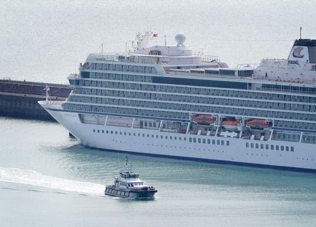 A Border Force boat passes a cruise liner docked at Dover 