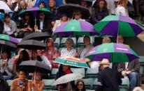 Britain Tennis - Wimbledon - All England Lawn Tennis & Croquet Club, Wimbledon, England - 1/7/16 Spectators wait during a rain delay on court 1 REUTERS/Andrew Couldridge