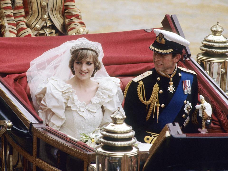 Princess Diana and Prince Charles ride in a horse-drawn carriage on their wedding day in 1981.