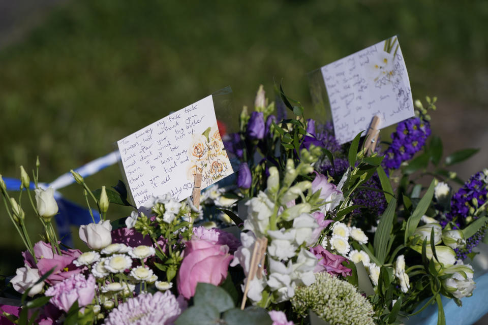 Messages left by the father to two of the victims on bouquets of flowers at the scene in Chandos Crescent, Killamarsh, near Sheffield, where four people were found dead at a house on Sunday. Derbyshire Police said a man is in police custody and they are not looking for anyone else in connection with the deaths. Picture date: Monday September 20, 2021.