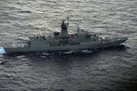 Australian ship HMAS Perth is guided into position by a New Zealand aircraft to recover an object during the search for missing Malaysia Airlines flight MH370, on April 13, 2014