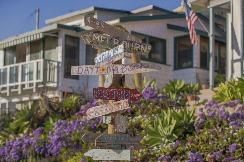 Newport Beach, CA - March 22: Beach goers enjoy the rustic scenery of the Crystal Cove Historical District, built as a seaside colony between 1920 and 1940, where fourteen individual cottages and ten dorm-style cottages with private rooms can be rented in Newport Beach Tuesday, March 22, 2022. The Crystal Cove Historic District and its century-old cottages are a historic coastal treasure. So far, twenty-eight cottages and one Japanese language schoolhouse have been fully restored, 17 north beach cottages are currently being renevated. (Allen J. Schaben / Los Angeles Times)