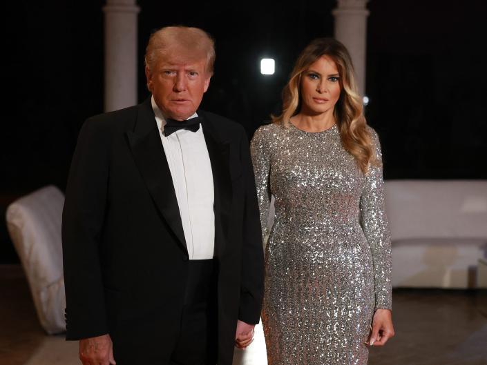 Donald Trump with Melania Trump addressing the press on New Year's Eve