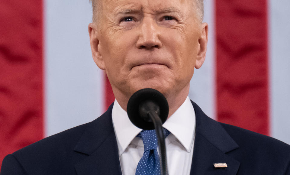 President Biden purses his lips in an expression of determination. 