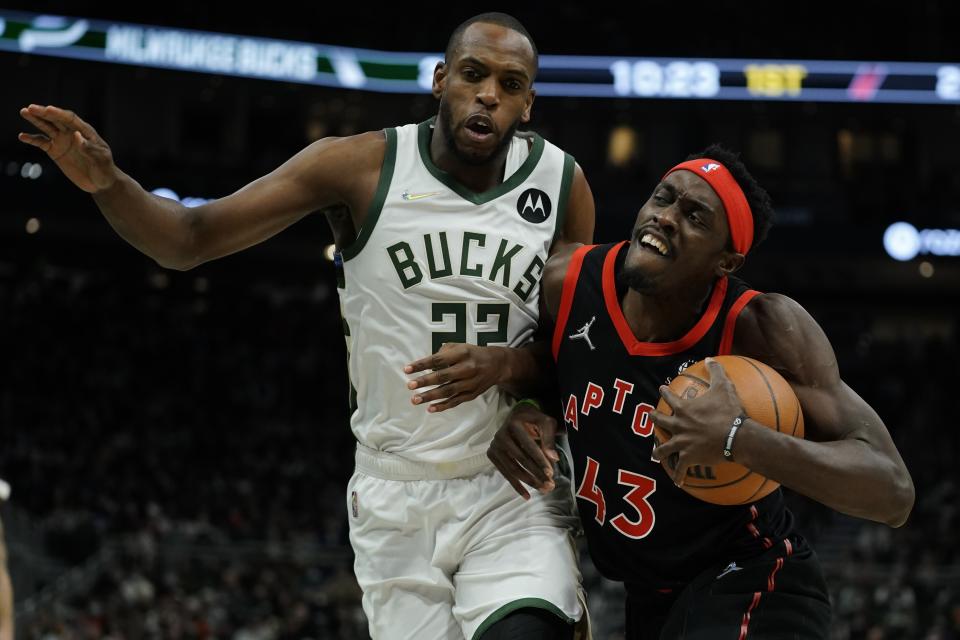 Toronto Raptors' Pascal Siakam tries to get past Milwaukee Bucks' Khris Middleton during the first half of an NBA basketball game Saturday, Jan. 15, 2022, in Milwaukee. (AP Photo/Morry Gash)