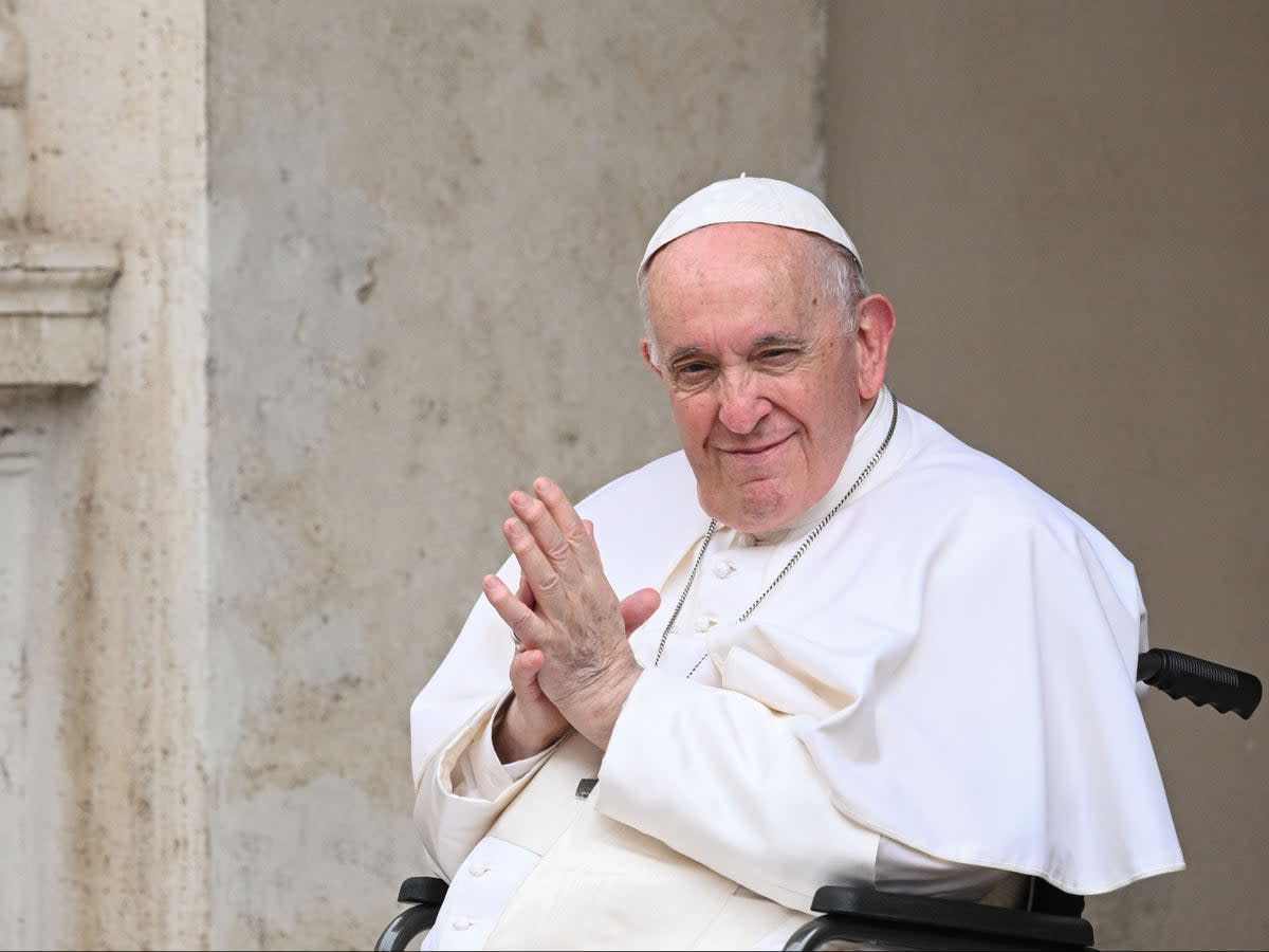 Pope Francis, seated in a wheelchair following knee treatment, presides over 