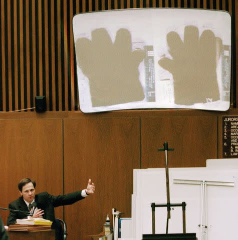 <p>AP Photo/David Sprague</p> Gary Sims showcasing a photograph of the gloves used in the murder of Nicole Brown Simpson and Ron Goldman