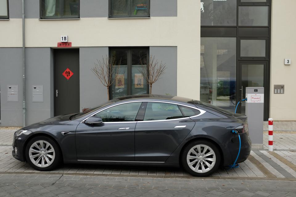 A Tesla Model S electric car charges at a public charging column on March 2, 2019 in Berlin (Getty Images)