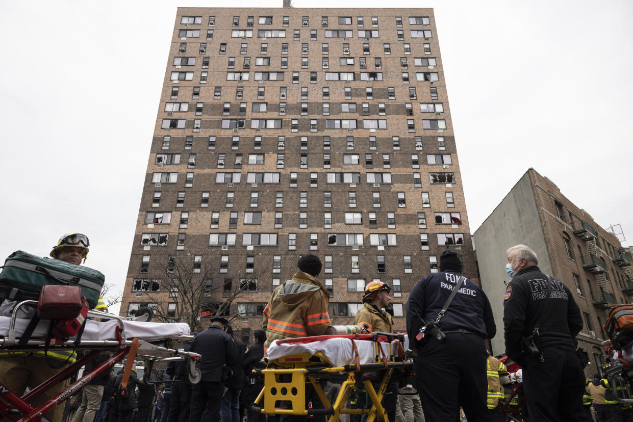 Emergency personnel work at the scene of the fire.