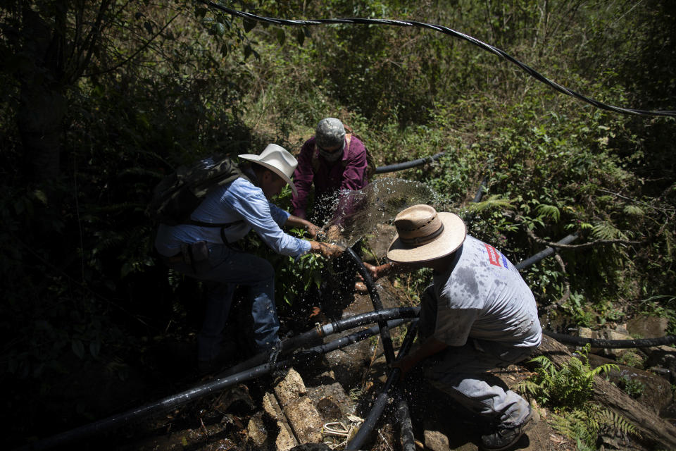 People dismantle an unlicensed water intake as their group of residents, farmworkers and small-scale farmers disconnect water taps in the mountains of Villa Madero, Mexico, Wednesday, April 17, 2024. As Mexico's drought drags on, angry farmers in Villa Madero have begun taking direct action to dismantle illegal water intakes which they say are drying up the streams in the mountains west of Mexico City. (AP Photo/Armando Solis)