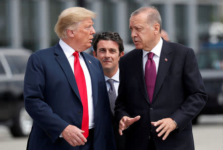 FILE PHOTO: U.S. President Donald Trump and Turkish President Tayyip Erdogan gesture as they talk at the start of the NATO summit in Brussels, Belgium July 11, 2018. REUTERS/Kevin Lamarque/File Photo