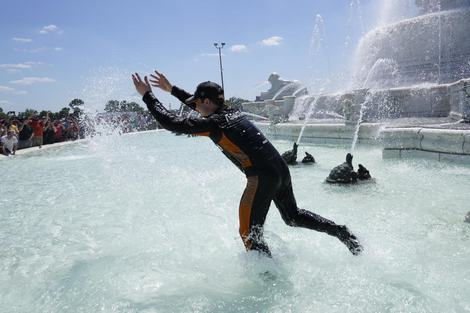 Pato O'Ward celebrates by jumping into James Scott Memorial Fountain after winning the second race of the IndyCar Detroit Grand Prix auto racing doubleheader on Belle Isle in Detroit Sunday, June 13, 2021. (AP Photo/Paul Sancya)