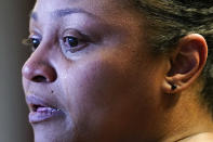 In this Sept. 23, 2021, photo Krystal Archie cries while she talks with an Associated Press reporter at her attorney's office in Chicago. Archie’s three children were present when police, on two occasions just 11 weeks apart, kicked open her front door and tore apart the cabinets and dressers searching for drug suspects. She’d never heard of the people they were hunting. Her oldest child, Savannah was 14 at the time; her youngest, Jhaimarion, was seven. They were ordered to get down on the floor. Telia, her third child, told the AP the scariest moment was seeing an officer press his foot into Savannah’s back. (AP Photo/Nam Y. Huh)