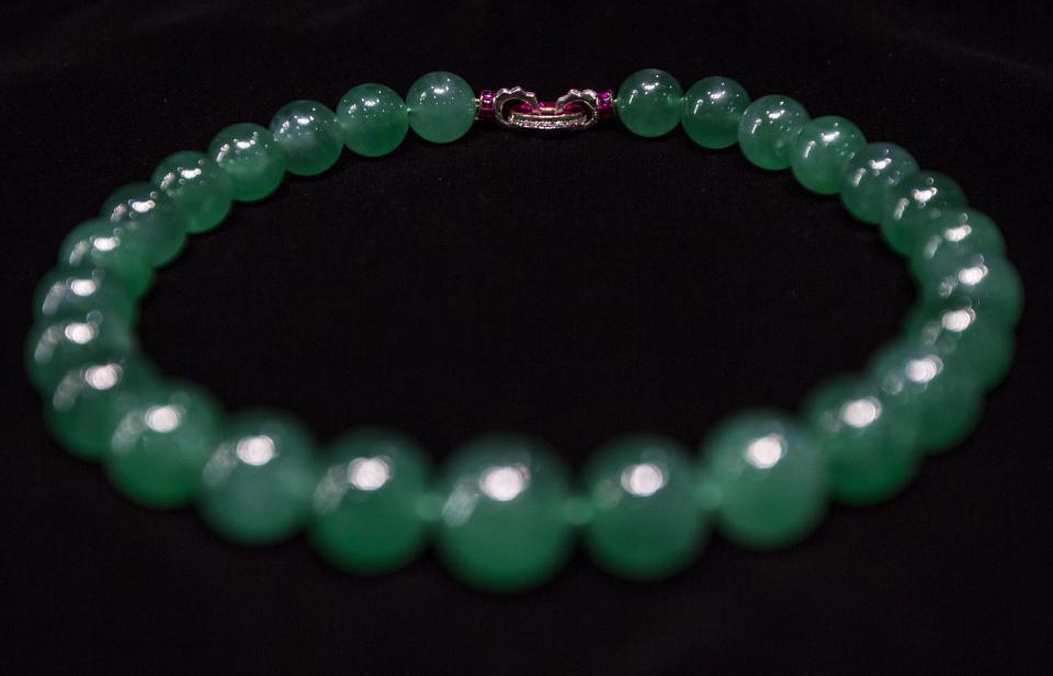 A "Hutton-Mdivani Necklace," composed of 27 graduated jadeite beads of highly translucent bright emerald green colour, set the record for jadette jewelry and for a Cartier piece sold at auction. The imperial Chinese jade necklace modified with a ruby and diamond clasp by Cartier in the early 20th century sold for 214,040,000 HKD (about $27M USD) on April 7, 2014, in Hong Kong. (REUTERS/Tyrone Siu)