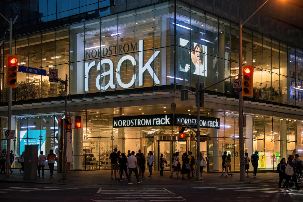 Toronto, Canada - August 8, 2022: Pedestrian Scramble crosswalk leading to Nordstrom Rack at the busy intersection of Yonge and Bloor streets. Nordstrom Rack is an American off-price department store chain that is a sister brand to the Nordstrom luxury department store chain.