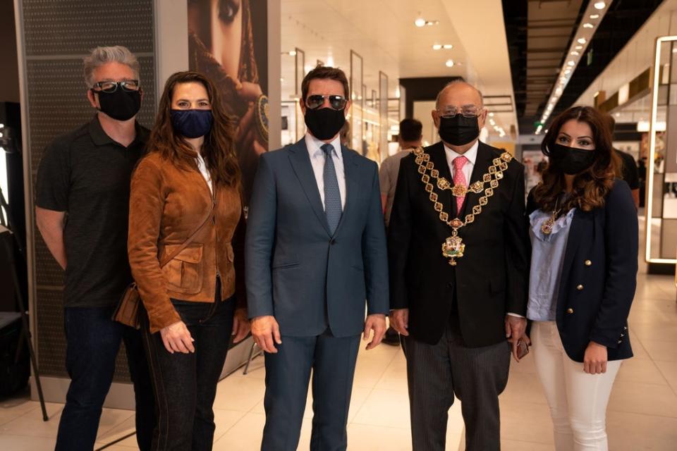 Tom Cruise with Mission: Impossible 7 co-star Hayley Atwell and director Chris McQuarrie posing for a photo with Muhammed Afzal, Lord Mayor of Birmingham, during a break from filming at Birmingham New Street station (Lord Mayor of Birmingham/PA) (PA Media)