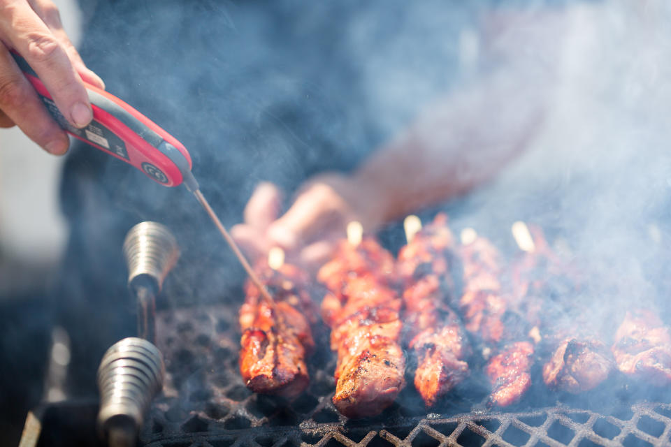 Pork on skewers cooked on barbecue grill.