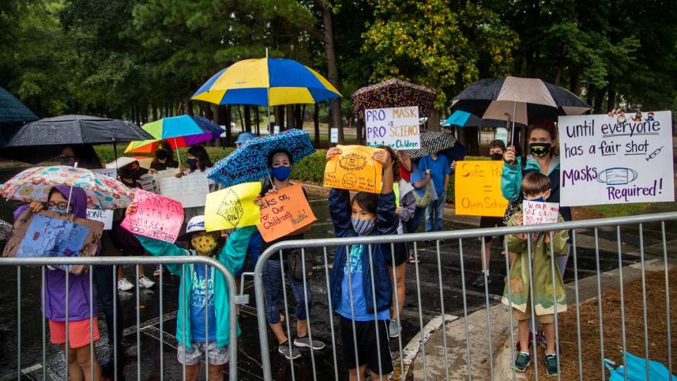 Protesters and counter-protesters demonstrate outside a Wake County Board of Education meeting Tuesday, Aug. 3, 2021 in Cary. The board will vote on a proposal to continue to require face masks in schools. Some parents argue the coverings should be optional.