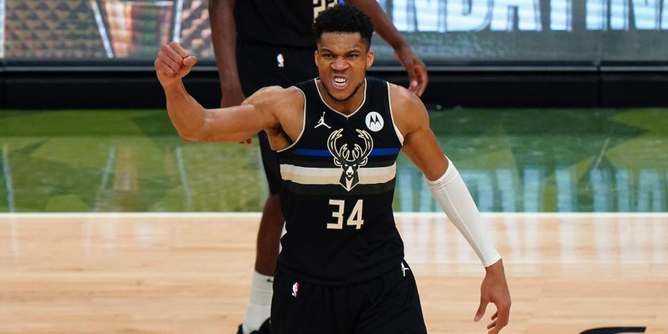 Giannis Antetokounmpo raises his first in celebration during the NBA Finals.