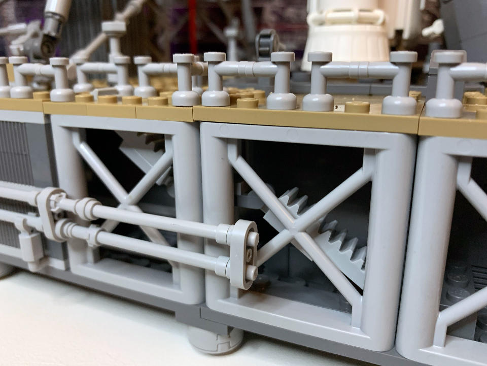 The mobile launcher in the new Lego NASA Artemis Space Launch System set has partly open sides showing interior details like pipes and staircases.