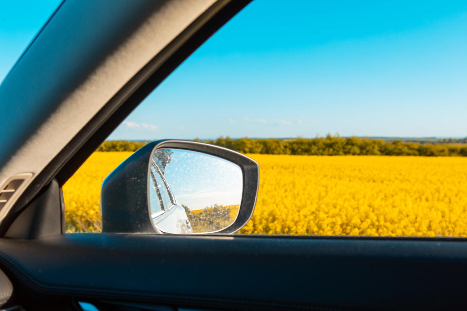 a car driving past a field