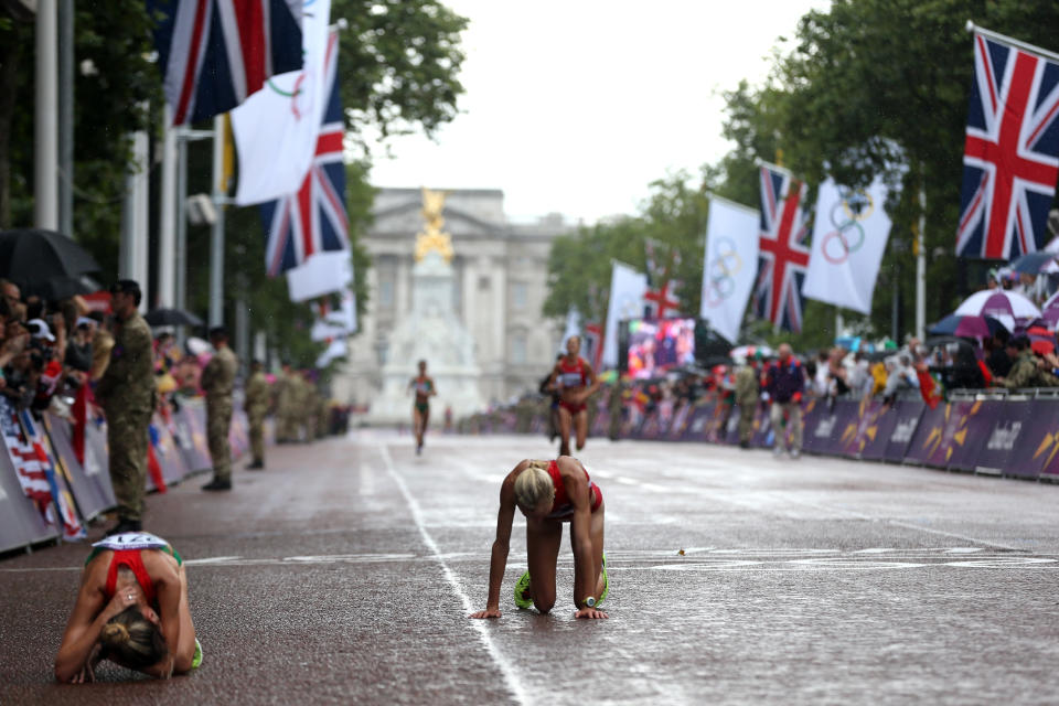 LONDON, ENGLAND - AUGUST 05: Athletes rest at the finish line during the Women's Marathon on Day 9 of the London 2012 Olympic Games on August 5, 2012 in London, England. (Photo by Streeter Lecka/Getty Images)