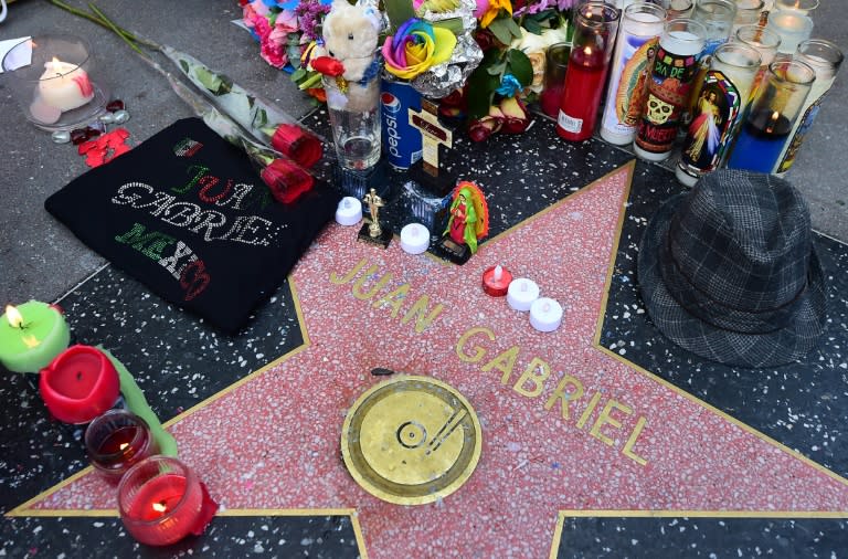 A display of flowers, candles, wreaths and other momentos placed in honour of the late Mexican music icon Juan Gabriel at his Star on the Hollywood Walk of Fame on August 29, 2016