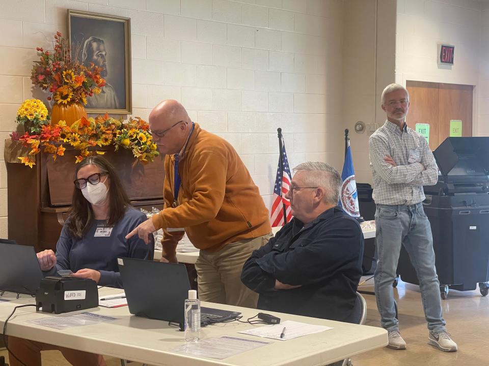 Charles Heffer (middle left, orange shirt) is the chief poll volunteer for Ward 1.