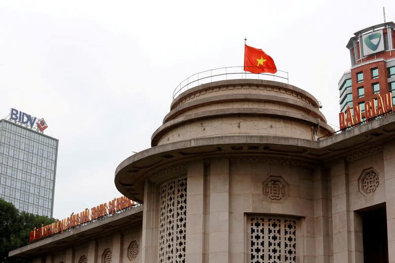 FILE PHOTO: A Vietnamese flag flies atop the State Bank building in central Hanoi