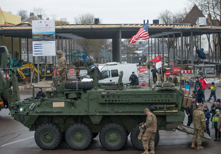 A US flag flies from the back of a tank parked in front of an Estonia-Russia border point during a military parade to celebrate 97 years since first achieving independence in 1918 on February 24, 2015 in Narva, Estonia