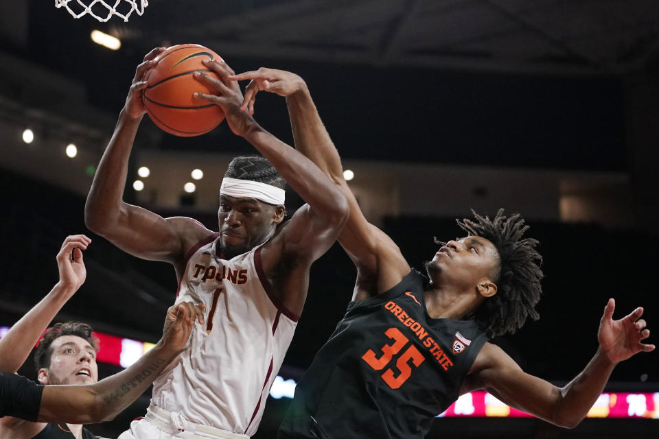 Southern California forward Chevez Goodwin, left, grabs a rebound away from Oregon State forward Glenn Taylor Jr. during the second half of an NCAA college basketball game Thursday, Jan. 13, 2022, in Los Angeles. (AP Photo/Mark J. Terrill)