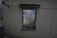 A burnt house in Kryoneri, in northern Athens, Greece, Friday, Aug. 6, 2021. Thousands of people have fled wildfires burning out of control in Greece and Turkey, including a major blaze just north of the Greek capital of Athens that left one person dead. (AP Photo/Petros Karadjias)