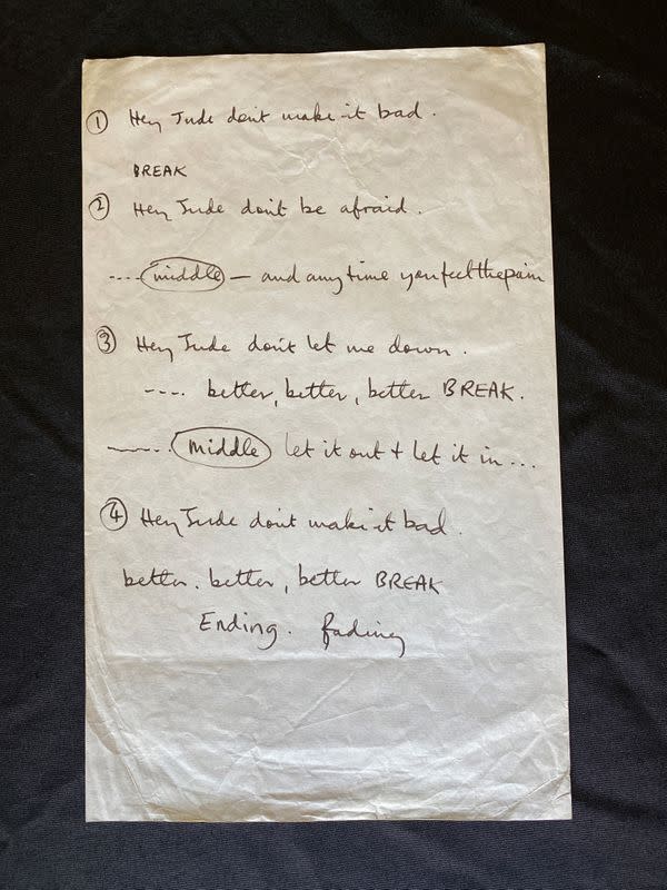 A sheet of paper with partial "Hey Jude" lyrics, written by Paul McCartney for a recording session in 1968, is displayed in a Julien's Auctions warehouse in Torrence, California