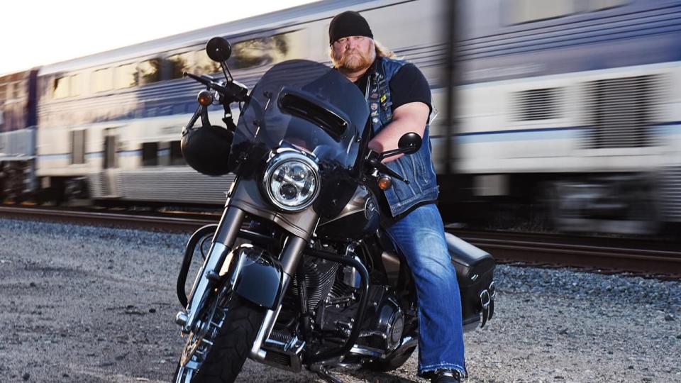 Stan Ellsworth sits on a motorcycle as part of his show.