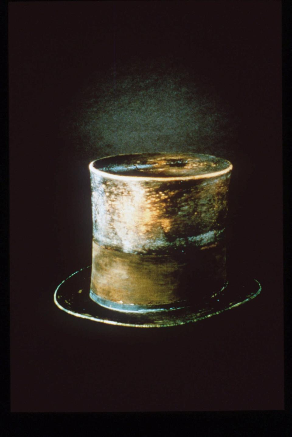 FILE - This undated file photo originally released by the Smithsonian, the top hat President Abraham Lincoln wore the night he was assassinated, is shown. Lincoln’s famous top hat, now brown and glossy with age, is currently on display at the Smithsonian's National Museum of American History in the “Changing America: The Emancipation Proclamation, 1863 and the March on Washington, 1963” exhibit. It's one of a number of Lincoln artifacts that history buffs can find in the Smithsonian collection in Washington D.C. (AP Photo/Smithsonan, file)