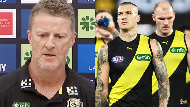 Damien Hardwick is seen left, with Dustin Martin leading Richmond players off the field on the right.