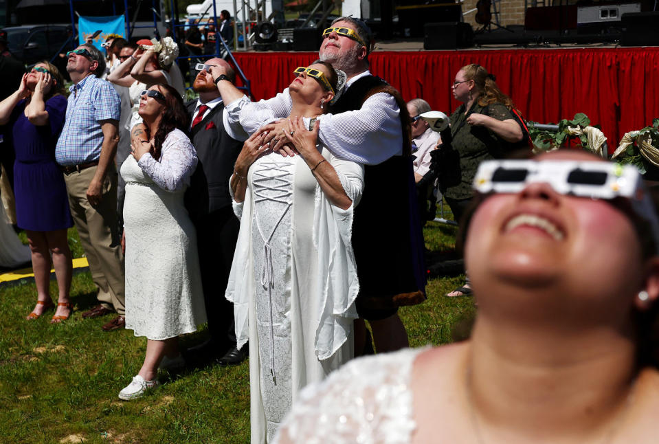 Image: Couples look at the eclipse during a mass wedding ceremony in Russellville, Ark. (Mario Tama / Getty Images)