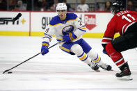 Buffalo Sabres' Dylan Cozens (24) controls the puck around Carolina Hurricanes' Jordan Staal (11) during the first period of an NHL hockey game in Raleigh, N.C., Thursday, April 7, 2022. (AP Photo/Karl B DeBlaker)