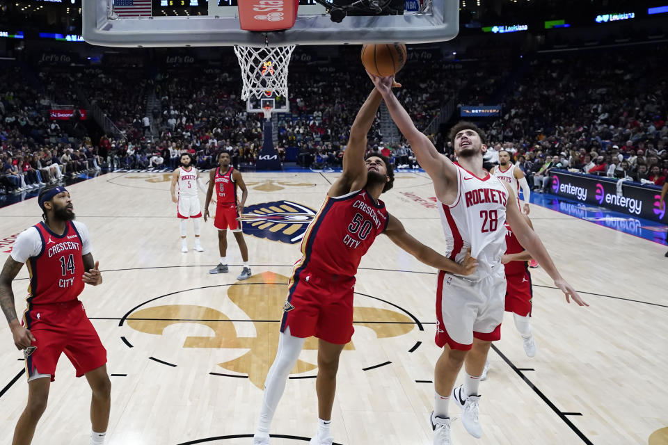 Houston Rockets center Alperen Sengun (28) goes to the basket against New Orleans Pelicans forward Jeremiah Robinson-Earl (50) in the second half of an NBA basketball game in New Orleans, Saturday, Dec. 23, 2023. The Rockets won 106-104. (AP Photo/Gerald Herbert)