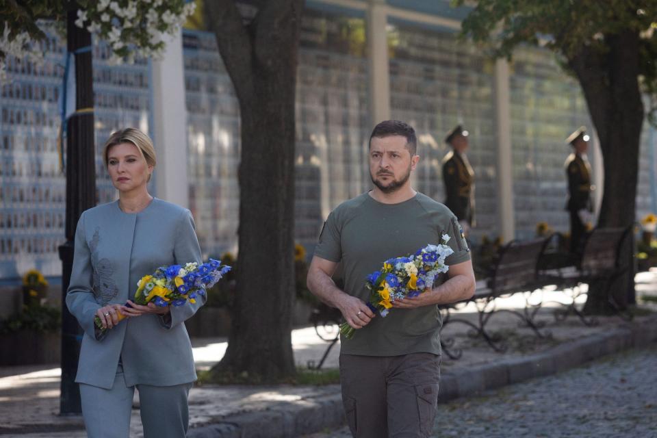 Volodymyr Zelensky and his wife Olena lay flowers at the Memory Wall of Fallen Defenders of Ukraine. (via REUTERS)
